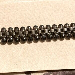 Edgy, yet elegant. This bracelet features metal links and black drop beads